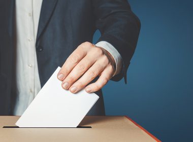 man placing ballot in box