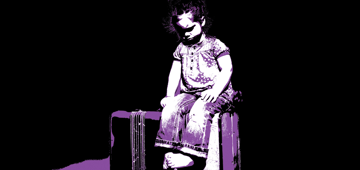 Child sits on a suitcase
