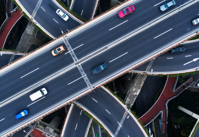 overhead view of intersecting motorways with cars