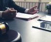 Two people having a meeting, writing on clipboards