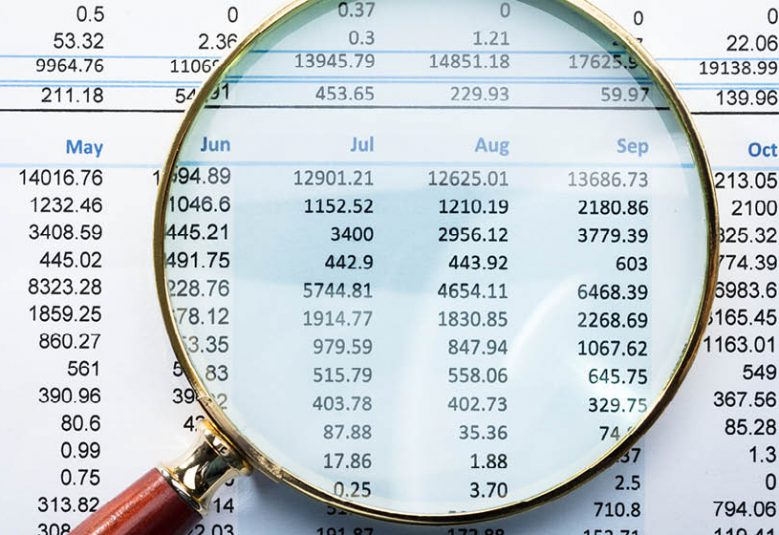 Magnifying glass highlighting figures on a financial statement