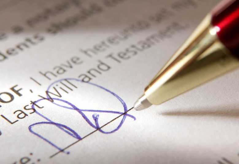 Close up of pen signing a will