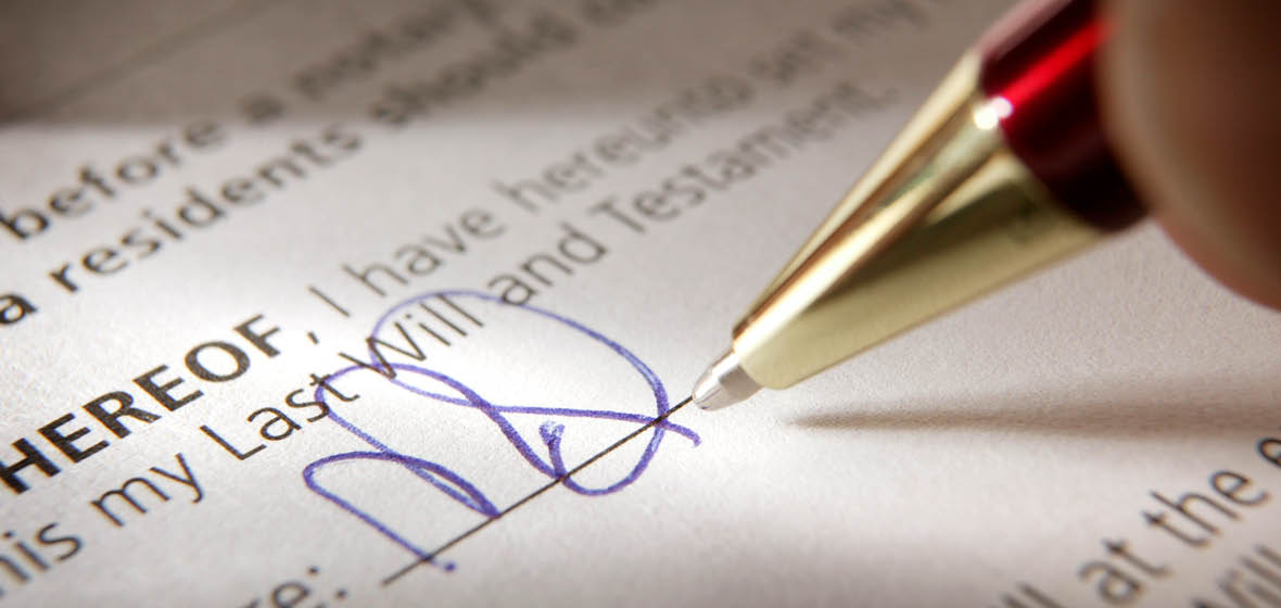 Close up of pen signing a will