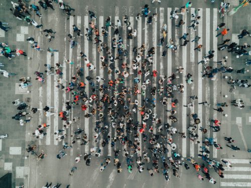Aerial view of a crowd crossing a pedestrian crossing