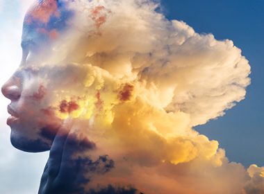 A woman's face superimposed over sky and clouds