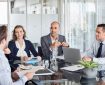 Colleagues sitting at a boardroom table