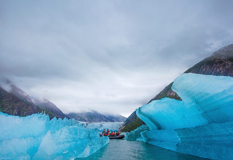 Group of people in boat in Alaska near glacier