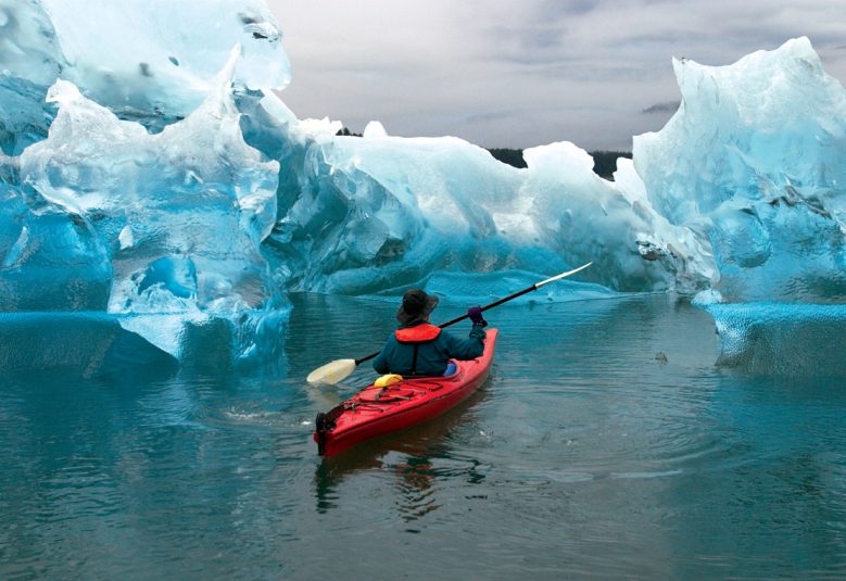 man kayaking in Alaksa near glaciers