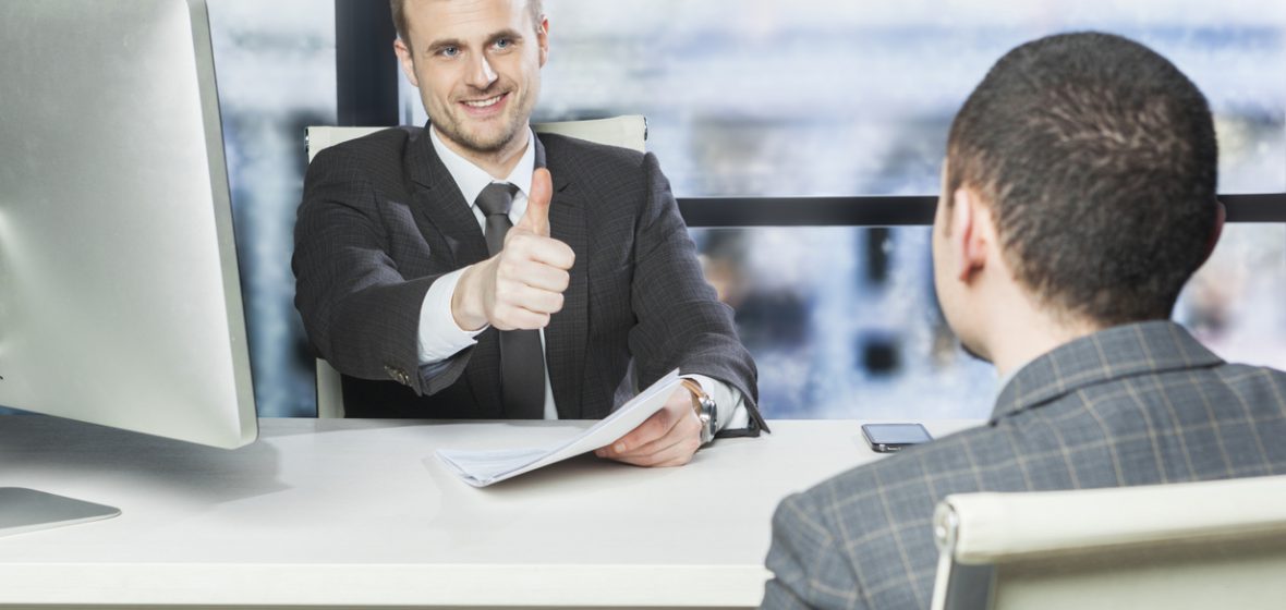 Employee gets thumbs up from manager during performance review