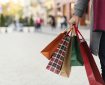 Man holding shopping bags with presents on the street