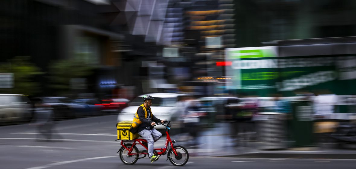 Person using bicycle for food delivery.