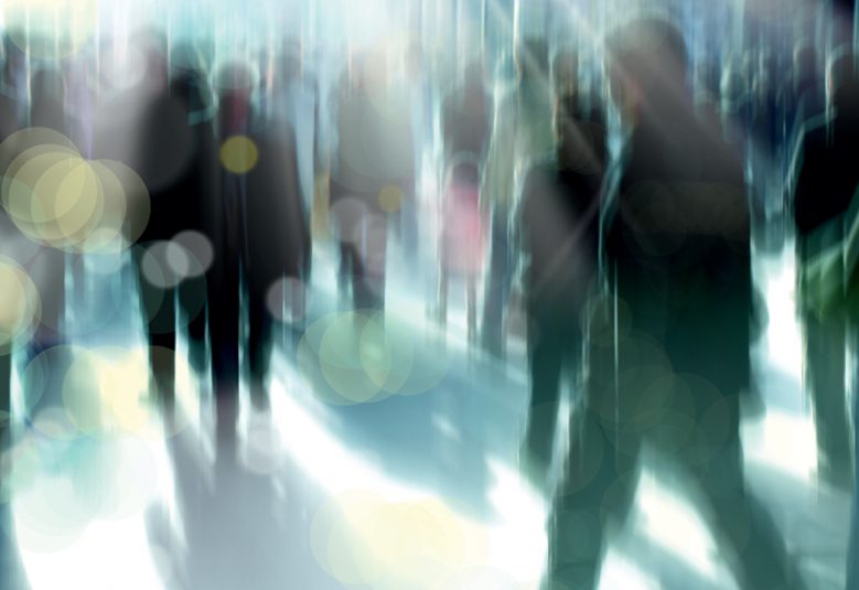 Blurred image of crowd walking in the city