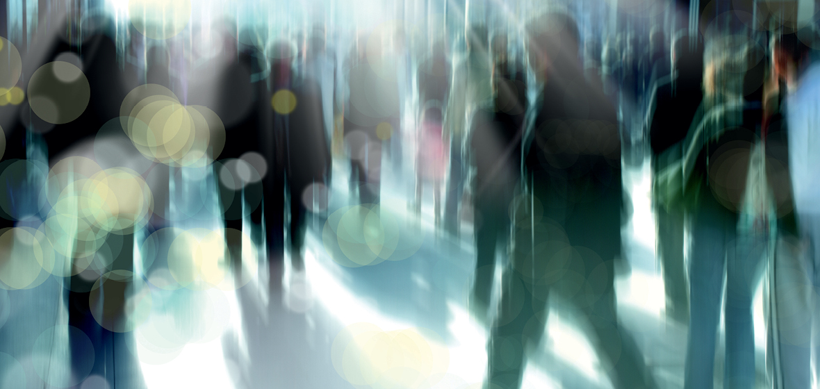 Blurred image of crowd walking in the city