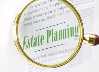 A magnifying glass focused on the words 'Estate Planning'