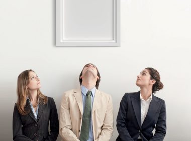 Three people looking up at an empty picture frame