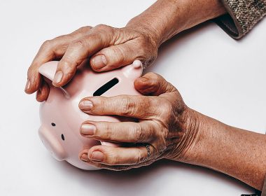 Older woman holds a piggy bank