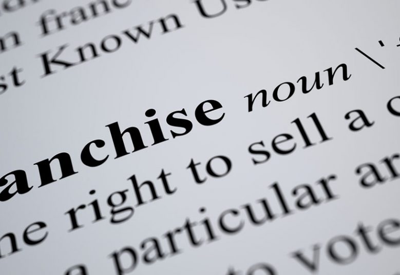 Close up of definition of franchise in the dictionary