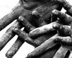 Closeup of adult and child hands covered in dust