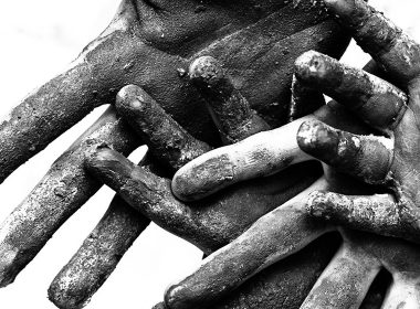 Closeup of adult and child hands covered in dust