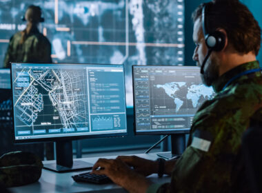 photo showing man in military camouflage doing data surveillance