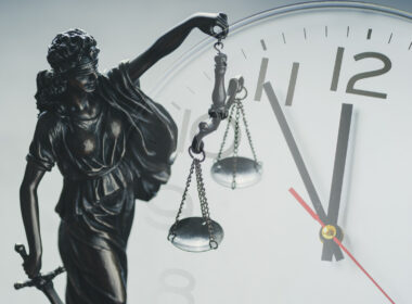 photo of sclaes of justice and clock to illustrate delays in coronial system