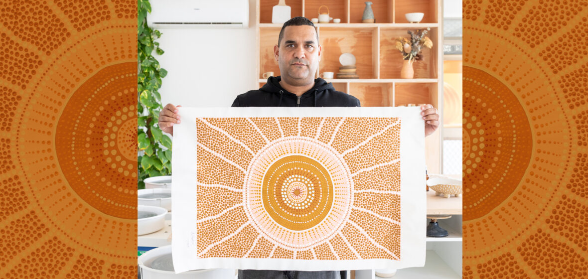 picutre of Indigenous man with art work to illustrate arts law centre work