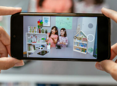 photo of hands holding phone showing child influencers