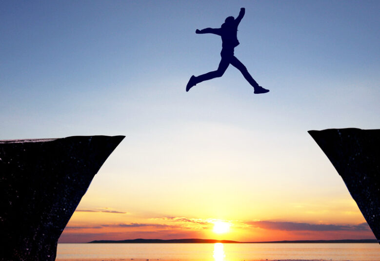photo of person leaping across a gap to show legal career offers access to other professions