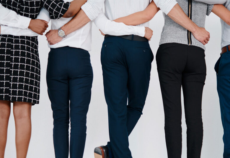 photo of people in business clothes with their arms around each other to illustrate being a mental health ally at work