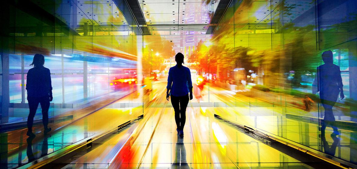 image of women walking towards the light in a colourful tunnel